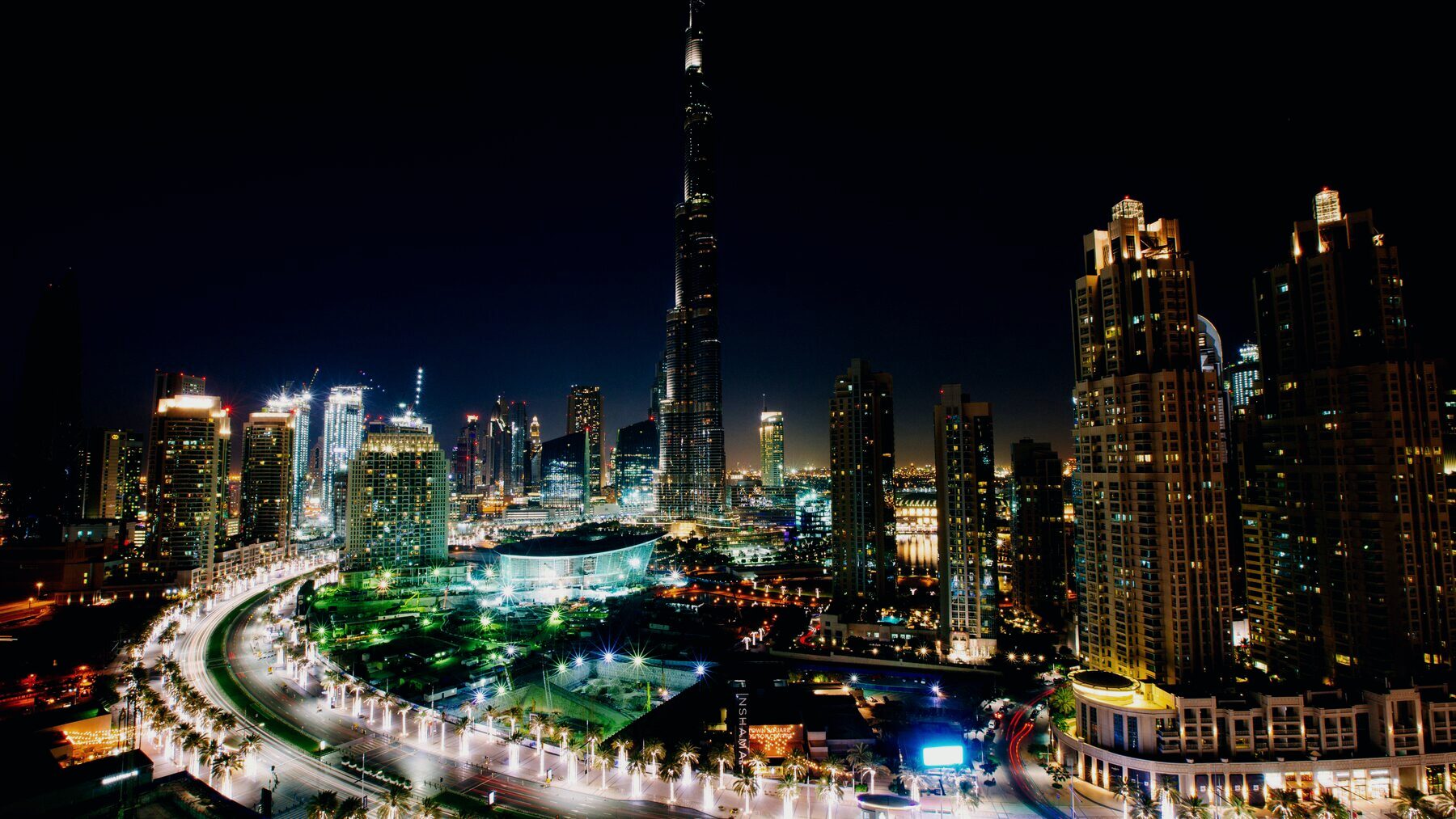 Downtown Dubai at night, with the Burj Khalifa lit above the surrounding residential towers