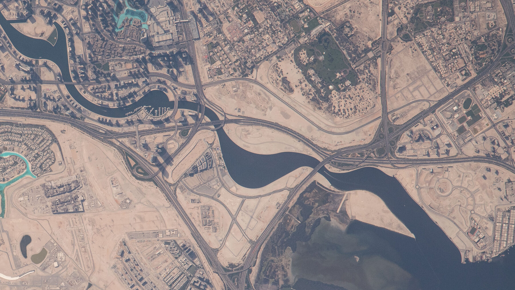 The Dubai Water Canal and Business Bay from orbit — the district where Al Sayyah's Blue Bay Tower stands