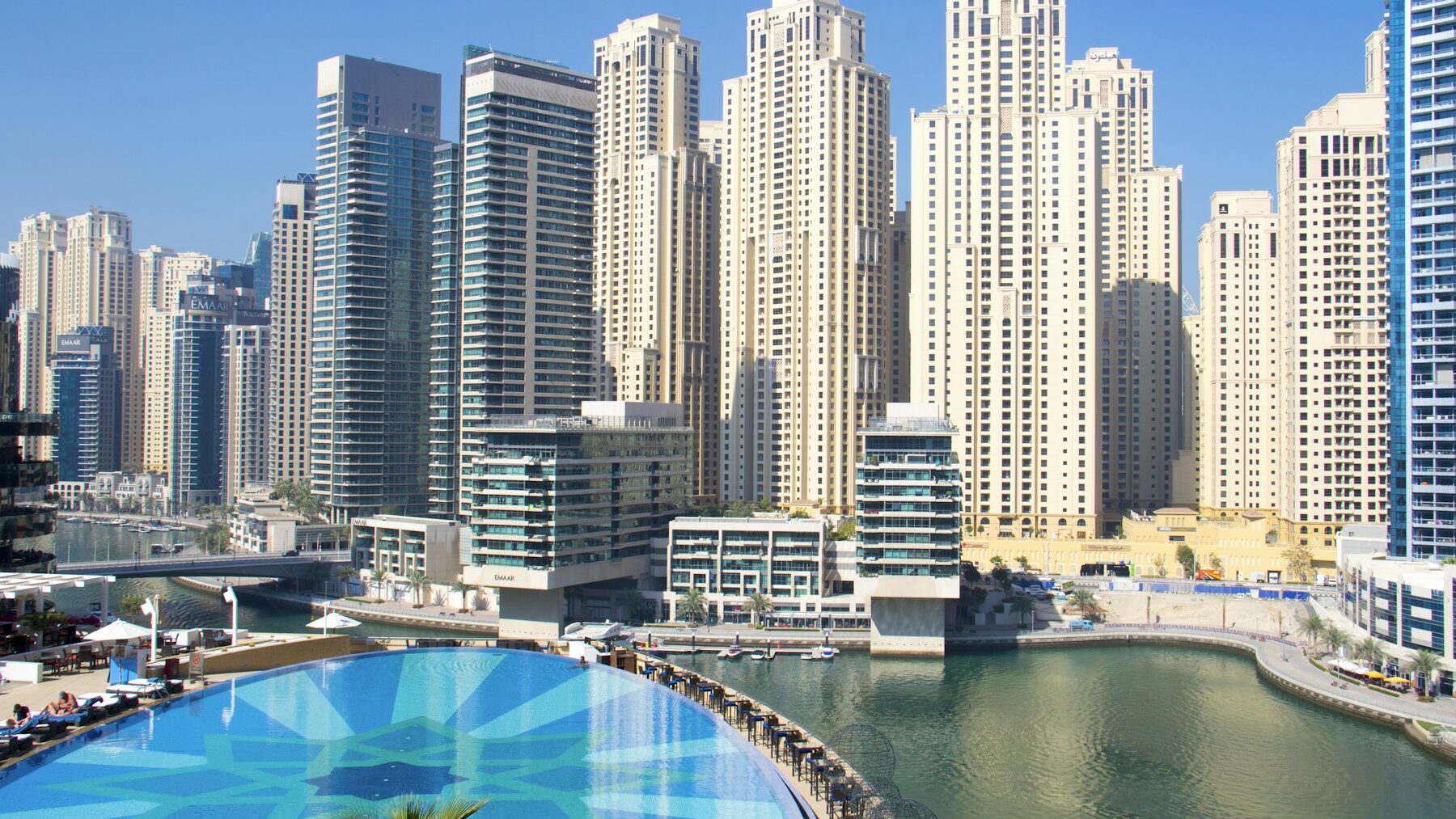 Pool and residential towers in a Dubai community