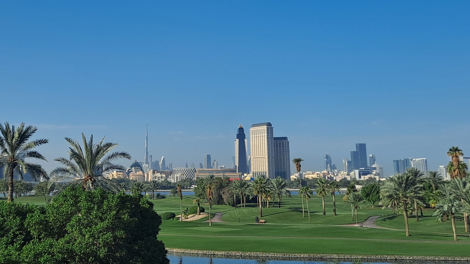 A park and skyline in Dubai — the green-frontage positioning that runs through Iman's One Park series