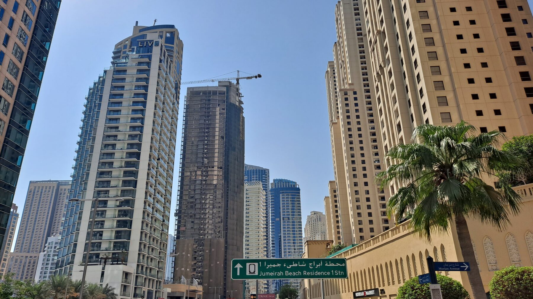 Street-level residential towers in Dubai, with construction ongoing alongside completed buildings
