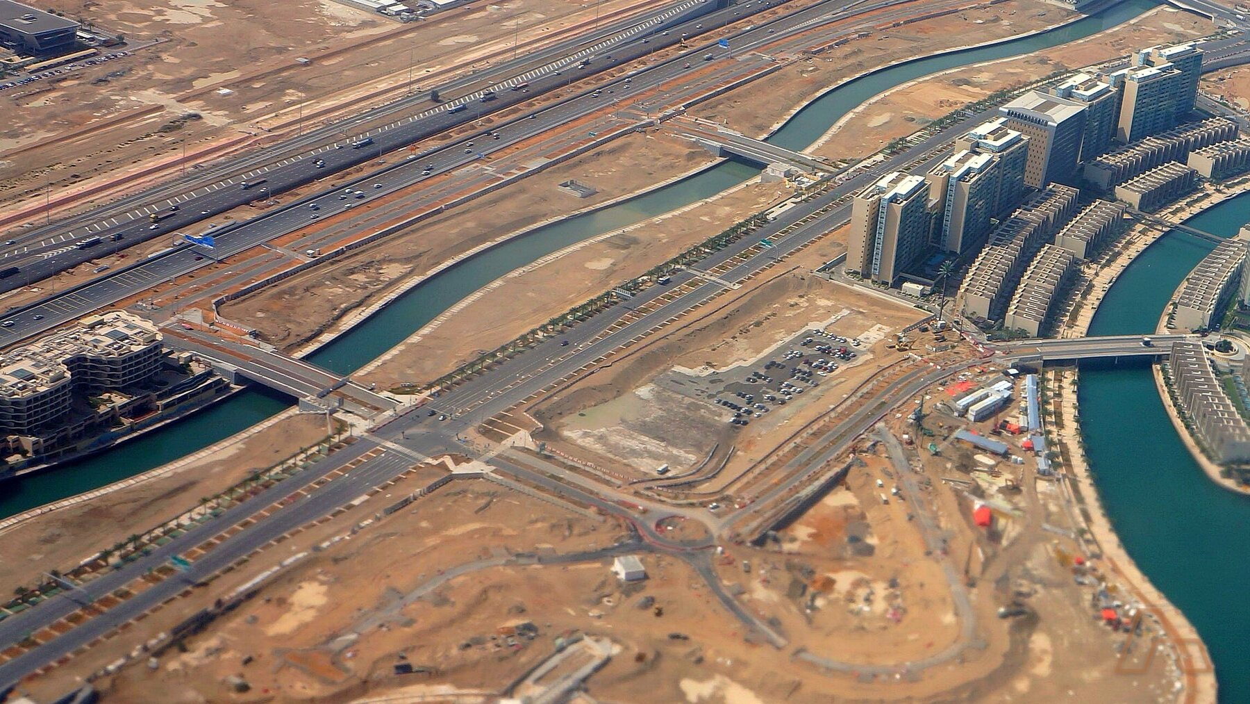 An aerial view of Al Raha Beach, Abu Dhabi — the kind of waterfront community district the capital's entry-level pipeline sits around