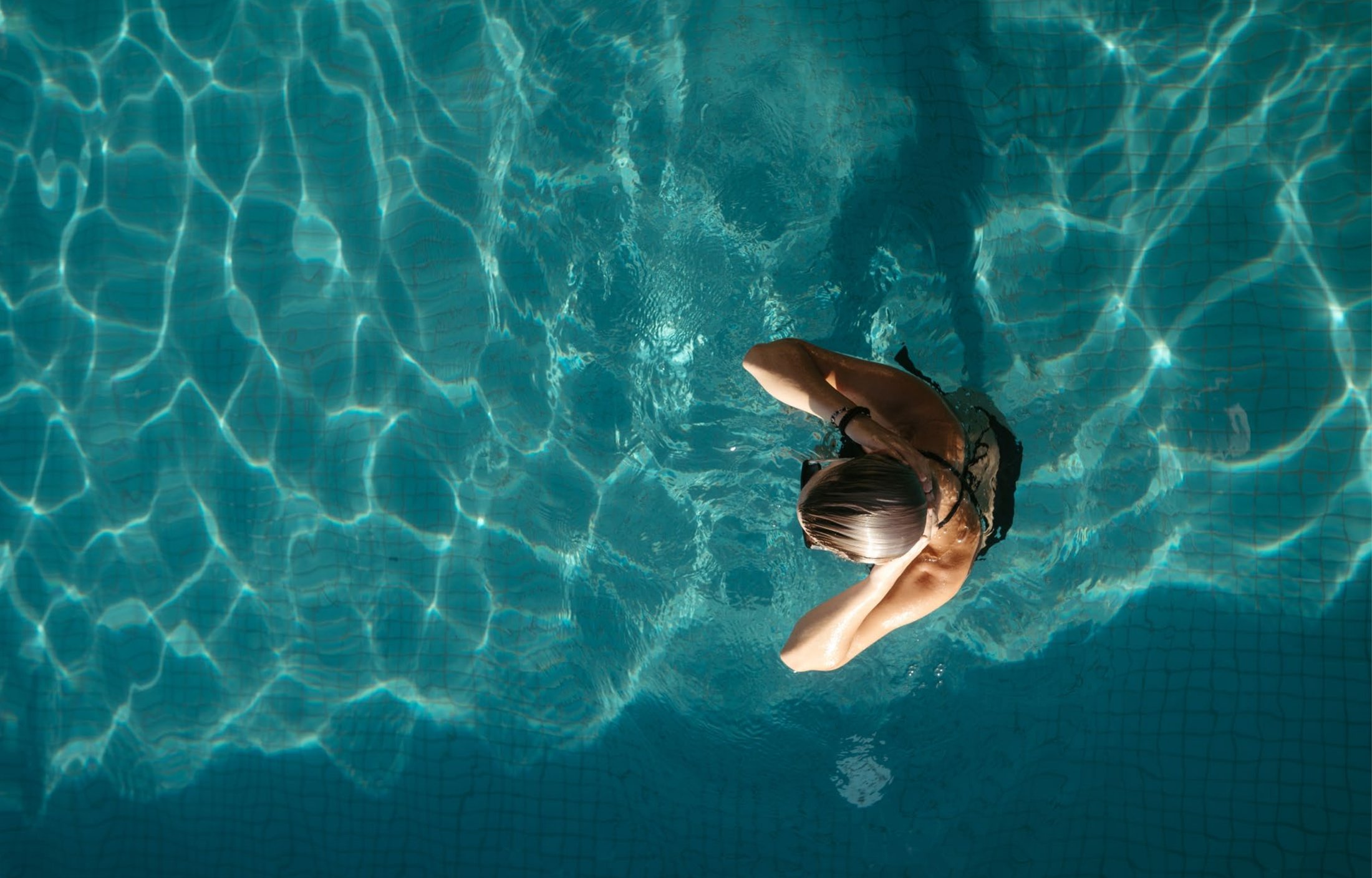 A resident enjoying the pool deck at a ZOYA development