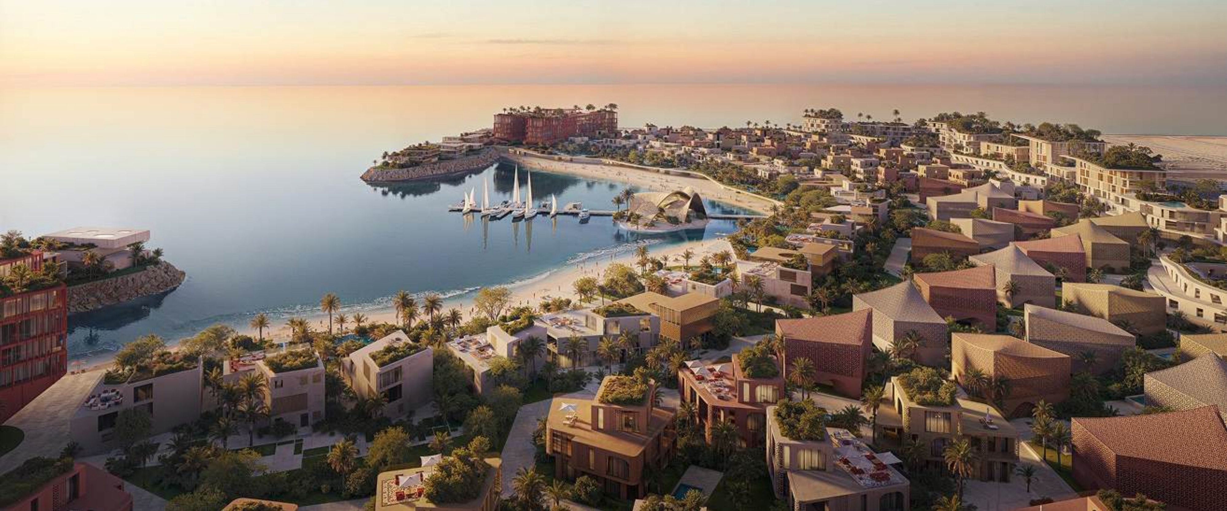 Aerial view of the Mira Coral Bay shoreline with beach clubs, marina and villas